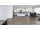 Open-concept kitchen with stainless appliances, granite counters, large island, and wood flooring at 200 Sweet Violet Dr, Youngsville, NC 27596
