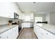 Bright kitchen with white cabinets, stainless appliances, granite countertops and a spacious island at 200 Sweet Violet Dr, Youngsville, NC 27596
