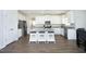 Bright kitchen featuring a granite island with seating, stainless appliances, and all-white cabinetry at 200 Sweet Violet Dr, Youngsville, NC 27596