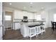 Bright kitchen featuring a granite island with seating, stainless appliances, and all-white cabinetry at 200 Sweet Violet Dr, Youngsville, NC 27596
