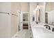 Bathroom featuring a dual vanity, modern fixtures, and a view into the main bedroom at 2027 Hopeton Ave, Raleigh, NC 27614