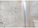 Bright bathroom features a tiled shower/tub combo with a built-in niche at 2027 Hopeton Ave, Raleigh, NC 27614
