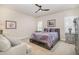 Comfortable bedroom with neutral walls, modern ceiling fan, and cozy furniture at 2027 Hopeton Ave, Raleigh, NC 27614