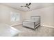 Clean bedroom with neutral walls, modern ceiling fan, carpet and natural light at 2027 Hopeton Ave, Raleigh, NC 27614