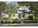Charming two-story home with a well-manicured lawn, white picket fence, and inviting front porch with an American flag at 2027 Hopeton Ave, Raleigh, NC 27614
