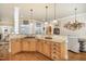 A kitchen with light wood cabinetry, granite countertops, and a gas cooktop at 2027 Hopeton Ave, Raleigh, NC 27614
