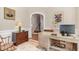 Home office with a wooden desk, a comfortable chair, and view to the staircase at 2027 Hopeton Ave, Raleigh, NC 27614