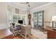 Bright and airy office space with a desk, chair, and large windows offering plenty of natural light at 2027 Hopeton Ave, Raleigh, NC 27614