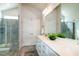 Bathroom featuring double sinks, closet, shower with glass doors, and modern finishes at 209 Stone River Dr, Wendell, NC 27591