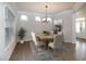 Elegant dining room with wood table, upholstered chairs, and decorative rug at 209 Stone River Dr, Wendell, NC 27591
