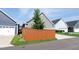 Street view of home with gray siding, a white garage door and a brown privacy fence at 209 Stone River Dr, Wendell, NC 27591