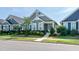 Charming gray two-story home with lush landscaping, sidewalk, and a welcoming teal front door at 209 Stone River Dr, Wendell, NC 27591