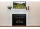 Close up of fireplace with decorative mantle, candle holders, and wall art at 209 Stone River Dr, Wendell, NC 27591