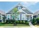 Charming home features a landscaped front yard, gray siding, and a welcoming turquoise front door at 209 Stone River Dr, Wendell, NC 27591