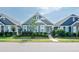 Charming home features a landscaped front yard, gray siding, and a welcoming turquoise front door at 209 Stone River Dr, Wendell, NC 27591