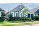 Charming home with manicured lawn, inviting front entrance, and gray horizontal siding at 209 Stone River Dr, Wendell, NC 27591