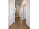 Bright hallway with wood floors, white trim, and multiple doorways to bedrooms at 209 Stone River Dr, Wendell, NC 27591