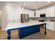 Modern kitchen features a large island, stainless steel appliances, and white cabinets at 209 Stone River Dr, Wendell, NC 27591