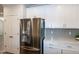 Modern kitchen with stainless steel refrigerator, white cabinets and updated countertops at 209 Stone River Dr, Wendell, NC 27591
