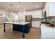 Bright kitchen boasts an island with seating and stainless steel appliances, ideal for cooking at 209 Stone River Dr, Wendell, NC 27591