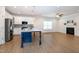 Spacious kitchen with a large island, stainless steel appliances, and a cozy fireplace at 209 Stone River Dr, Wendell, NC 27591