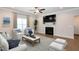 Inviting living room with fireplace, ceiling fan and hardwood floors at 209 Stone River Dr, Wendell, NC 27591