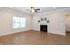 Bright living room with ceiling fan, hardwood floors and fireplace at 209 Stone River Dr, Wendell, NC 27591
