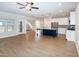 Open-concept living area features a kitchen island, modern appliances, and stylish flooring at 209 Stone River Dr, Wendell, NC 27591