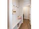 The mudroom is equipped with a bench, storage shelving, hooks, and light wood floors at 209 Stone River Dr, Wendell, NC 27591