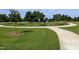 Beautiful community park with artistic structures, a sidewalk, green grass and mature trees at 209 Stone River Dr, Wendell, NC 27591
