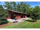 Red outdoor pavilion with a concrete base, bench seating, a trash can, and lush green grass at 209 Stone River Dr, Wendell, NC 27591