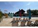 Resort-style pool area with lounge chairs, umbrellas, and a waterslide for Gathering fun and relaxation at 209 Stone River Dr, Wendell, NC 27591