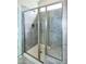 This shower features a glass door, a tiled shower bench, and a shower head at 209 Stone River Dr, Wendell, NC 27591