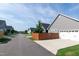 Street view of homes with gray siding, white garage doors and brown privacy fences at 209 Stone River Dr, Wendell, NC 27591