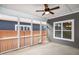 The screened porch features a ceiling fan, neutral paint and access to the yard at 209 Stone River Dr, Wendell, NC 27591