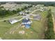 Aerial view of a two-story home with a pool in a residential area with tree-lined streets and open fields at 241 Fox Run, Benson, NC 27504