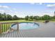 Picture perfect backyard with an above-ground pool, expansive green space, and beautiful landscaping at 241 Fox Run, Benson, NC 27504