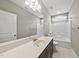 Bathroom features a double sink vanity with a large mirror and a combination tub and shower at 241 Fox Run, Benson, NC 27504