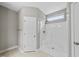 Bright bathroom features a tiled floor, white door, and a white shower with a small window above at 241 Fox Run, Benson, NC 27504