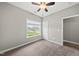 Bedroom with carpet, ceiling fan, light gray walls and one window with a view of the yard at 241 Fox Run, Benson, NC 27504