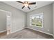 Bedroom with carpet, ceiling fan, one window with neighborhood view, and access to bathroom at 241 Fox Run, Benson, NC 27504