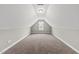 A clean and bright carpeted bonus room features vaulted ceilings and a window at 241 Fox Run, Benson, NC 27504