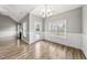 Open dining area with hardwood floors, chair railing, a chandelier, and view to back yard at 241 Fox Run, Benson, NC 27504