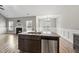 Open kitchen with island, stainless dishwasher and sink, granite countertops and view of living room with fireplace at 241 Fox Run, Benson, NC 27504