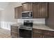Close up of oven and microwave, part of stainless appliances in a modern, updated kitchen at 241 Fox Run, Benson, NC 27504