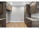 Walk-in pantry with granite countertop, abundant brown cabinets, wood floor and lots of storage at 241 Fox Run, Benson, NC 27504