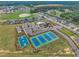Aerial view of the community with a pool, tennis courts, playground, and well-maintained landscaping at 243 E Wellesley Dr, Clayton, NC 27520