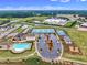 Aerial view of community amenities: pool, tennis courts, parking, playground, and landscaping at 243 E Wellesley Dr, Clayton, NC 27520