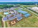 Aerial view of community amenities, showcasing the pool, tennis courts, and playground area at 243 E Wellesley Dr, Clayton, NC 27520