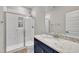 Bathroom with walk-in shower, subway tile, granite countertops and blue cabinets at 243 E Wellesley Dr, Clayton, NC 27520